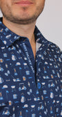 A close-up of a man wearing a navy blue short-sleeve button-up shirt with a white and light blue pattern of household items and the text 'BEST DAD BY PAR' on the inner placket.