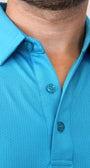 Close-up of a man wearing a bright turquoise blue short-sleeve polo shirt with a textured micro-perforated fabric and matching buttons.