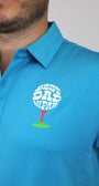 A close-up of a man wearing a bright blue polo shirt with a custom golf-themed chest graphic. The graphic features a white golf ball with the words 'BEST DAD BY PAR' in white, resting on a red tee over a green patch of grass.