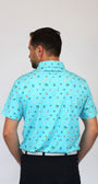 A man viewed from behind wearing a light blue short-sleeve collared shirt with a small all-over Coastal Links, Myrtle Beach, SC, Beach-theme pattern, paired with black pants, against a plain light gray background.