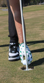 Person preparing to putt and he is removing the golf ball from the hole in a premium 'Clover Luck' golf glove