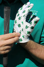 'Clover Luck' golf glove with shamrock pattern and little golf flags on a person hand close-up 