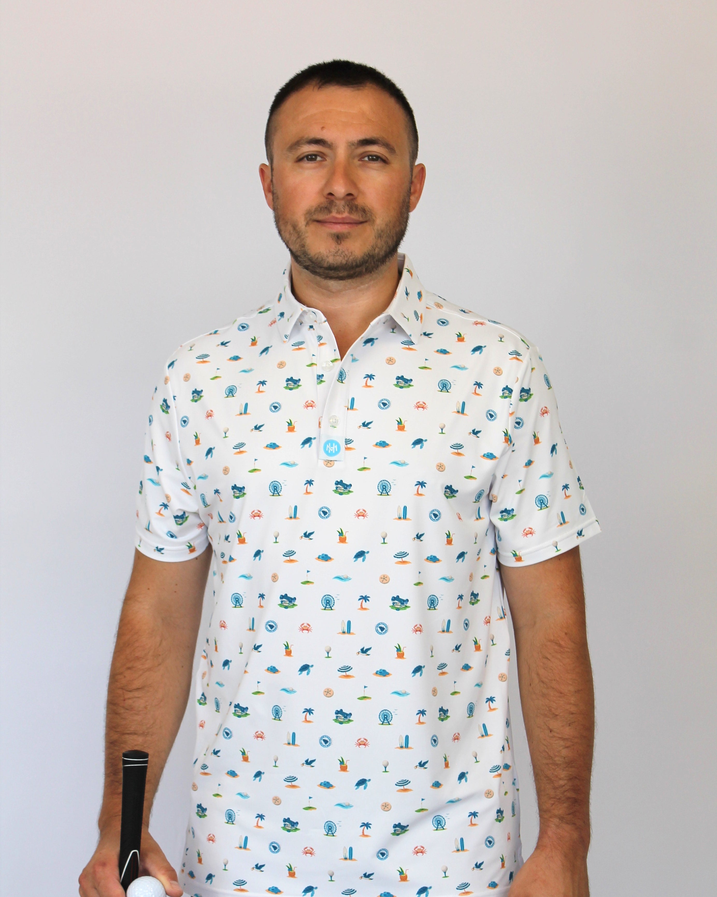 A man wearing a white short-sleeve button-up shirt with a colorful golf-themed and beach-theme, Myrtle Beach, SC pattern, holding a golf club and ball.
