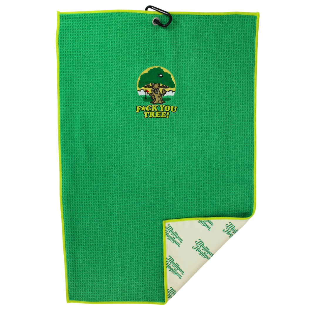 A green textured golf towel with a black hanging loop at the top and a small embroidered logo reading 'F*CK YOU TREE!' on the front. The bottom corner is folded over to show the off-white reverse side with green printed text.