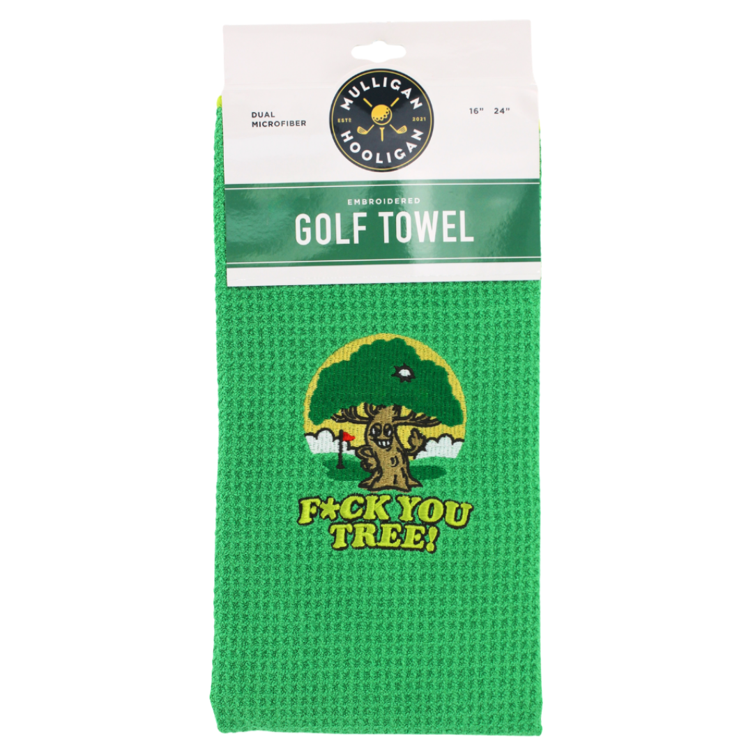 A green waffle-weave golf towel with a humorous graphic of a tree and the text 'F*CK YOU TREE!' printed on it, packaged in its original white and green header card.
