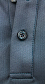 Close-up of a button on a gray fabric surface