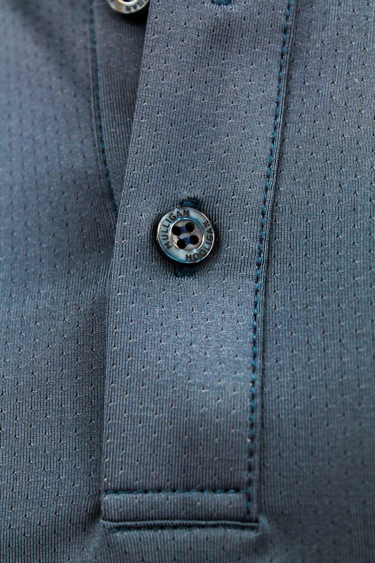 Close-up of a button on a gray fabric surface