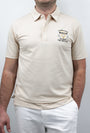 A man wearing a beige polo shirt with the chest artwork: 'It takes a Lot of Balls to play the way I do' with short sleeves, standing against a plain background.