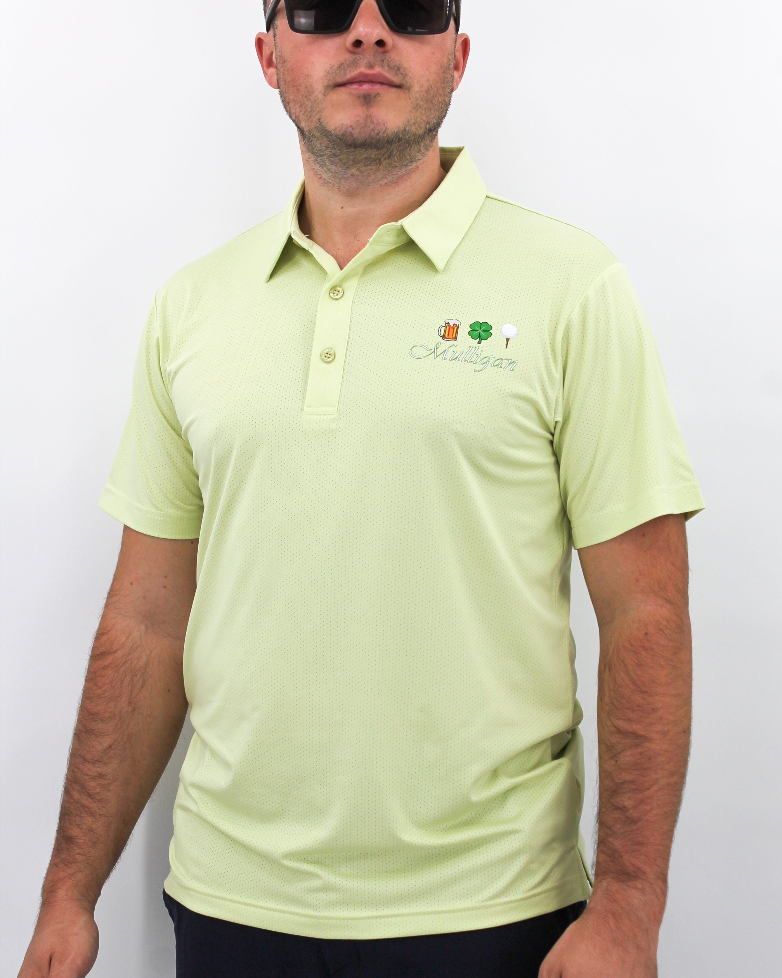 Man wearing a light green polo shirt with 'Mulligan' chest logo on a white background