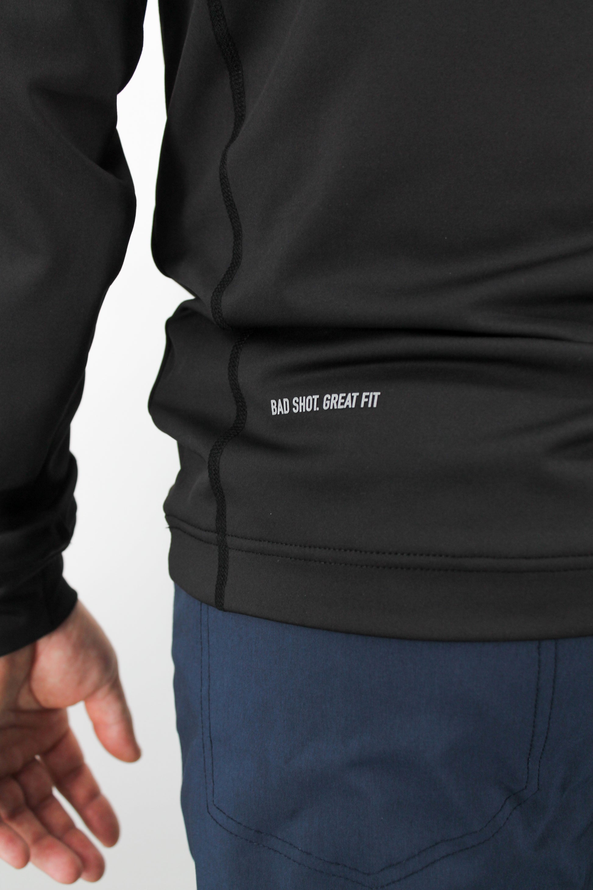 Black Q-Zip with 'Bad Shot. Great Fit' text on a white background