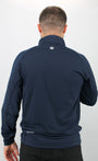 Man wearing a navy blue jacket with a logo on the back against a white background