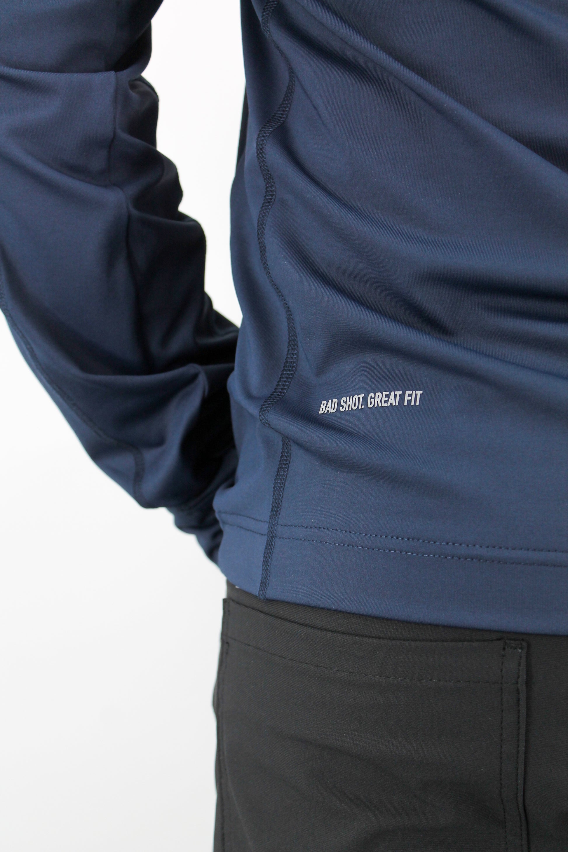 Navy blue jacket with text 'Bad Shot. Great Fit' on a white background