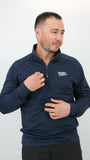 Man wearing a navy blue pullover with a logo on a white background