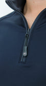 Close-up of a navy blue zip-up garment with a brand logo on the zipper.