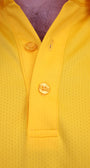 Close-up of a bright yellow perforated polo shirt showing the collar, 3 yellow buttons, and a textured fabric surface.