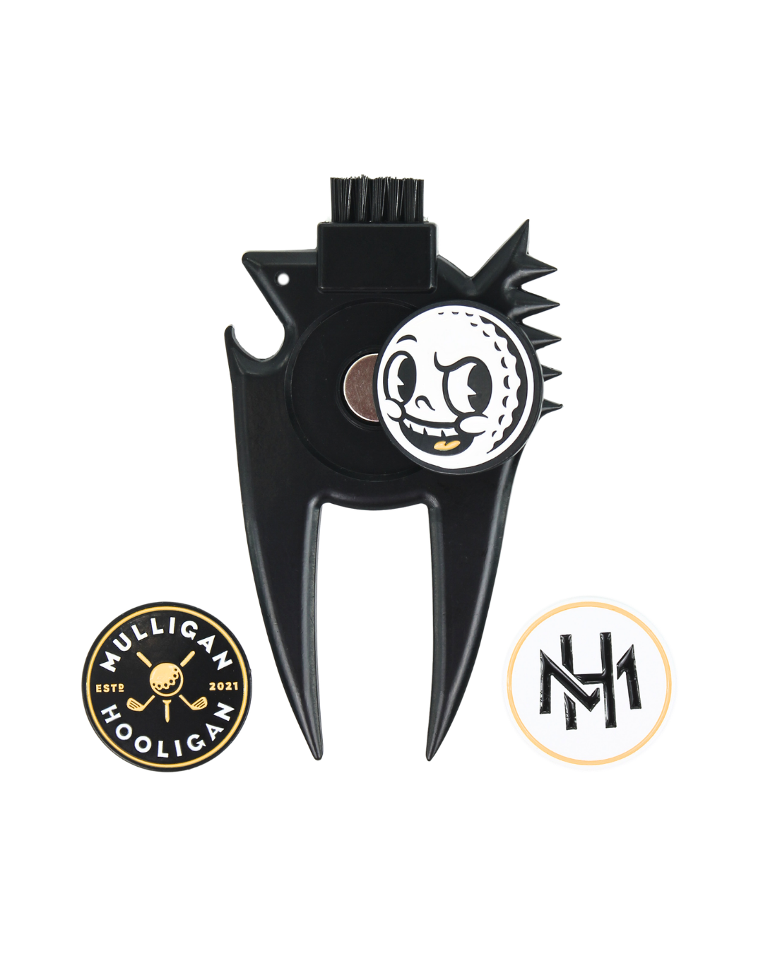 A black metal golf divot tool with a skull-and-golf-ball emblem in the center, shown on a plain white background with two circular brand logos below it.
