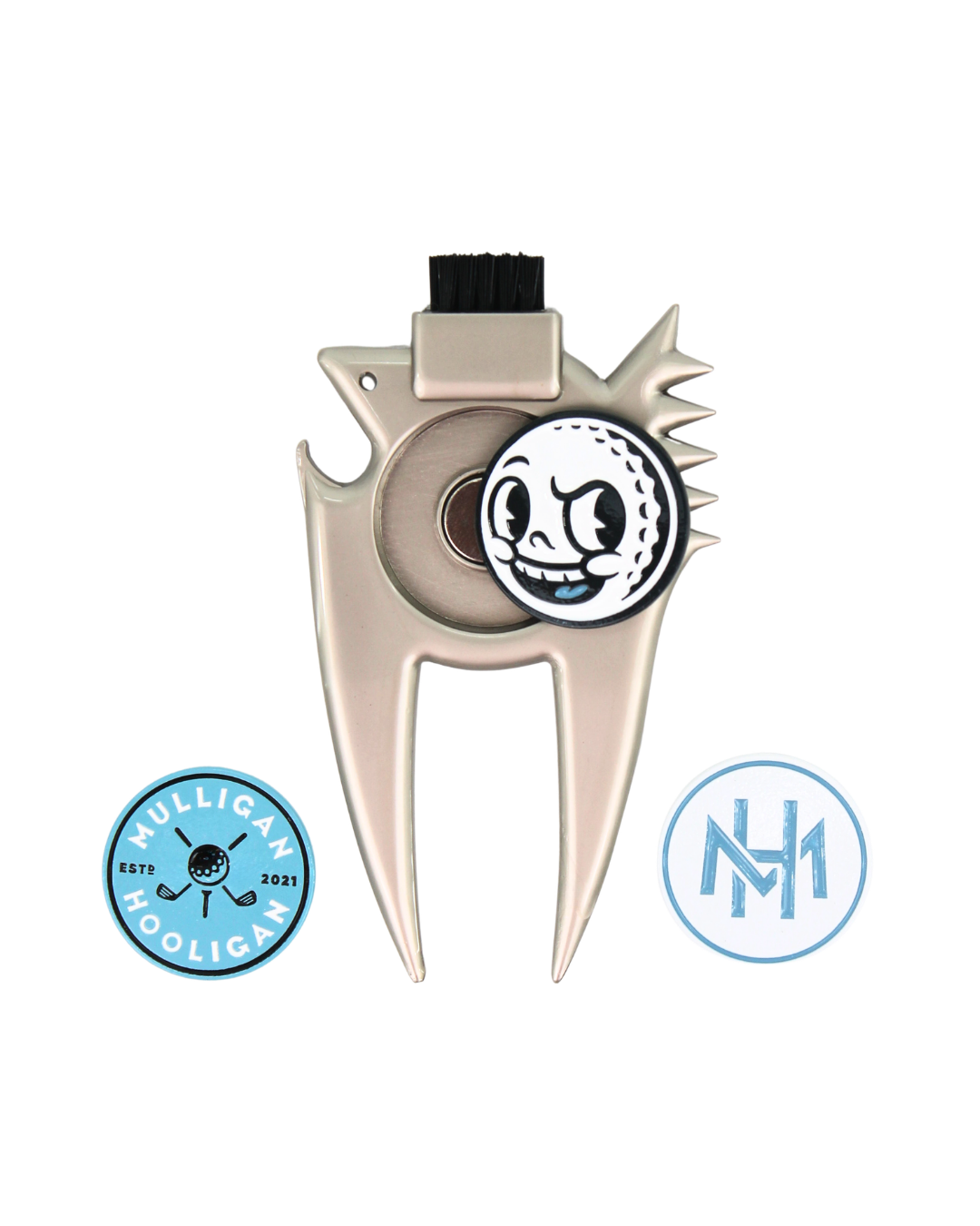 A metallic beige golf club head repair tool with a black cleaning brush on top and a circular golf ball charm featuring a cartoon face. Two circular blue and white badges are displayed on either side of the tool against a plain white background.