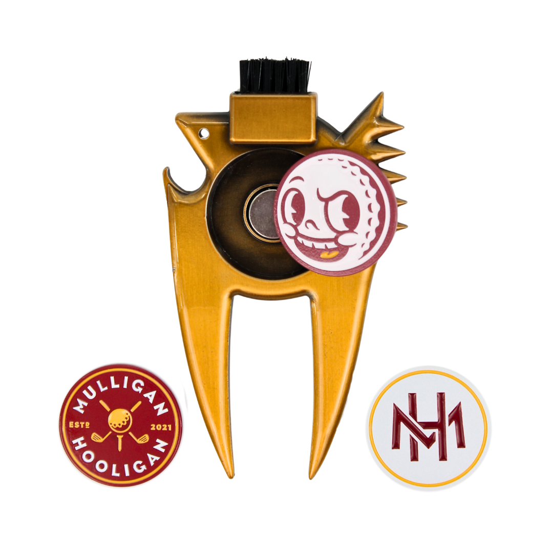 Gold metal golf club head repair tool with a black cleaning brush on top, shown on a white background with two circular branded patches: a red and white 'Mulligan Hooligan' patch and a white and red 'MH' patch.