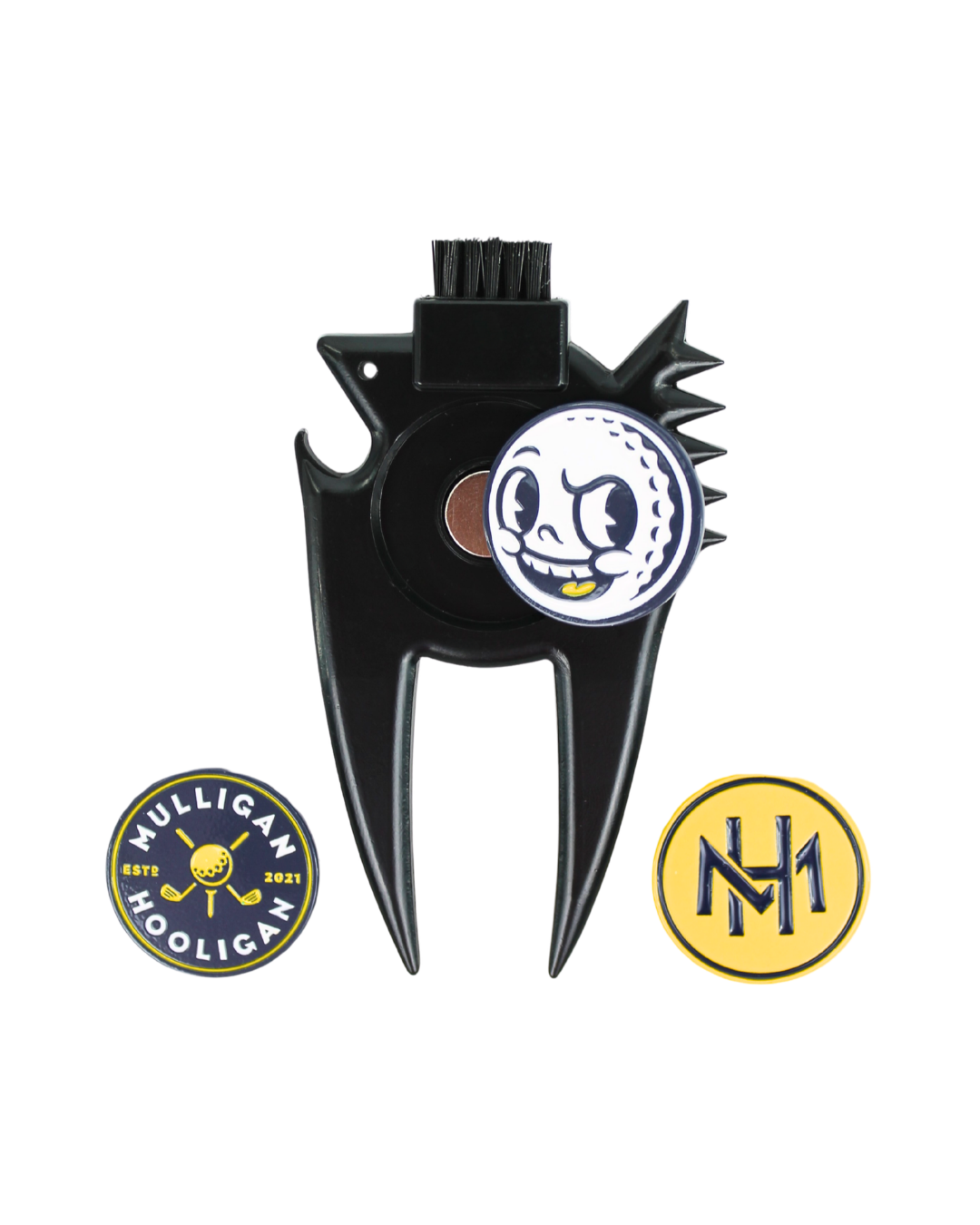 A black plastic golf club fairway divider with a built-in brush on the top, featuring a circular white and blue golf ball graphic on the center. Two circular metal emblems are shown below: one with the text 'MULLIGAN HOOLIGAN' in blue and yellow, and another with a yellow 'NH' monogram.