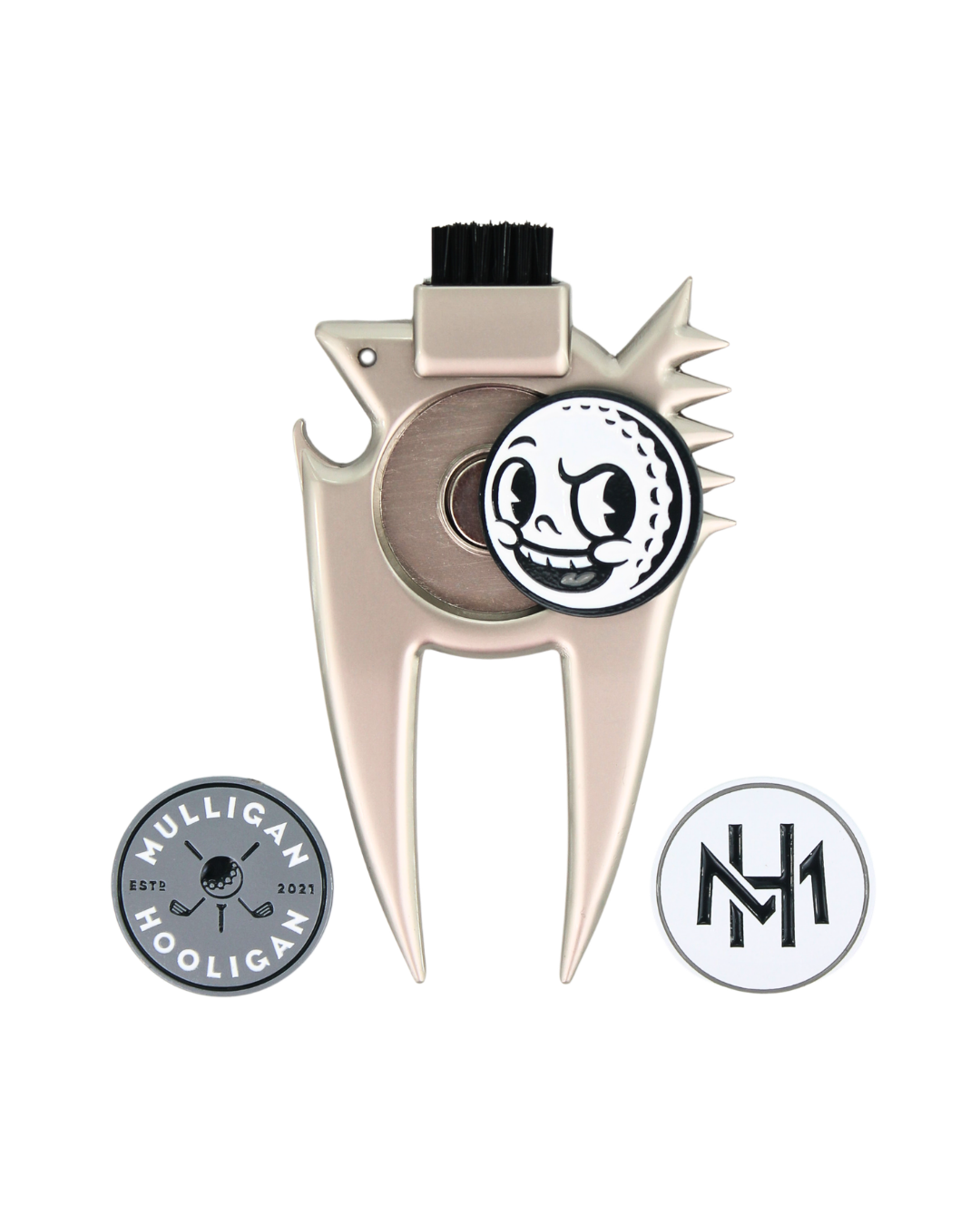 A silver metal golf club head repair tool with a black bristle brush on top and a circular black-and-white cartoon golf ball emblem in the center. Two circular badges are shown below: one reading 'Mulligan Hooligan' and one with an 'MH' logo, all on a plain white background.