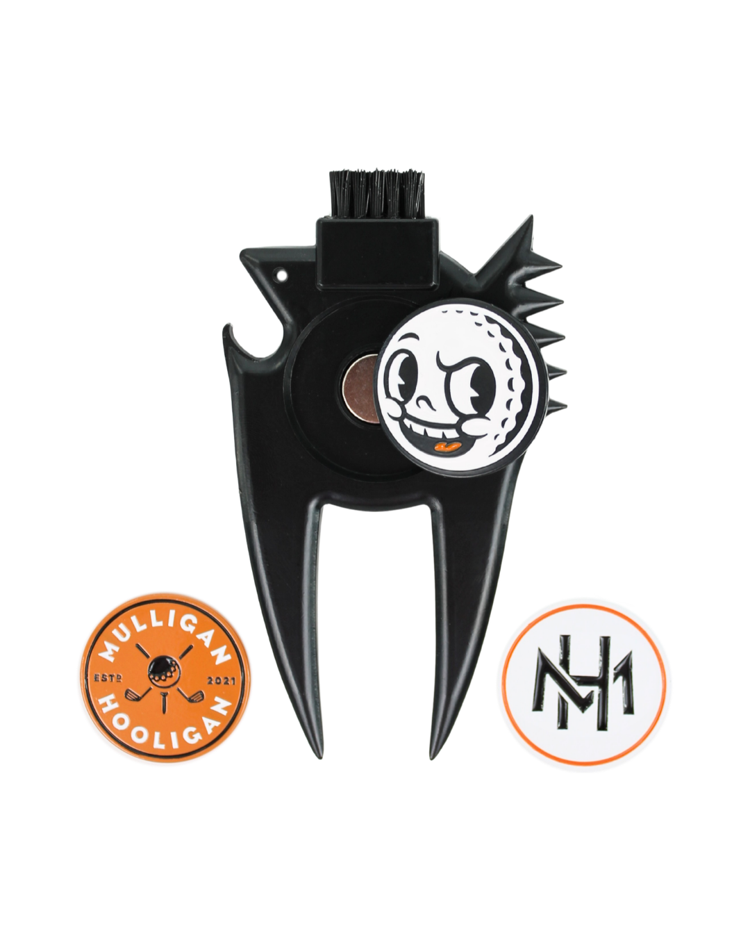 A black metal golf club divot remover and brush with a cartoon golf ball graphic, shown on a white background with two circular brand badges below.