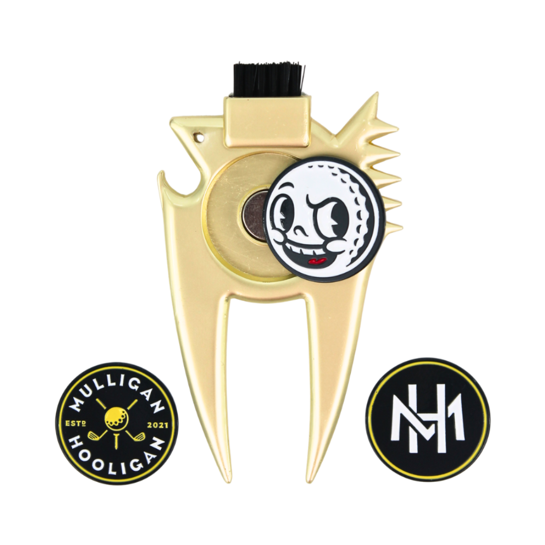 Gold metal golf flag pull with a black loop at the top and a cartoon golf ball emblem in the center, shown on a white background with two circular black-and-gold badges below.