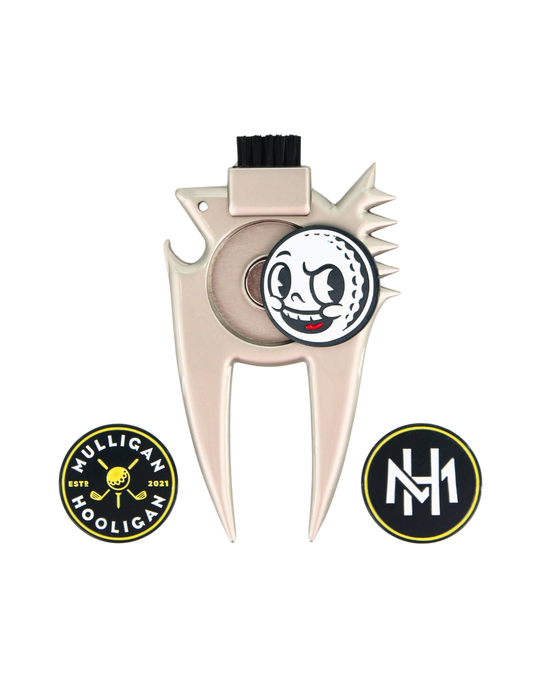 A metallic beige golf club head repair tool with a black bristle brush on top, a cartoon golf ball emblem, and two circular patches below on a white background.