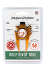 Mulligan Hooligan golf divot tool in its original blister card packaging. The multi-function tool is gold-colored with a black handle and features various engraved and printed labels including 'Club Brush', 'Magnetic Ball Marker', and 'Groove Cleaner'.