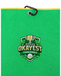 A bright green textured golf towel with a black hanging loop and a yellow edge trim, featuring a central embroidered crest that reads 'World's Okayest Golfer' with a trophy, golf ball, and green leaves.