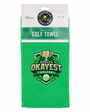 A bright green waffle-weave golf towel in its retail packaging, featuring a 'World's Okayest Golfer' logo on the front.